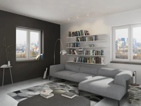 Ventana de PVC oscilobatiente Hermet 10 en salón con sofá gris y estantería de libros