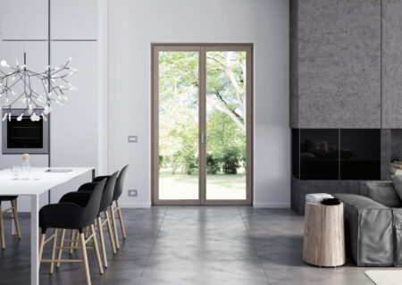 Balconera de PVC acabado madera clara en cocina-comedor moderna con vistas al jardín